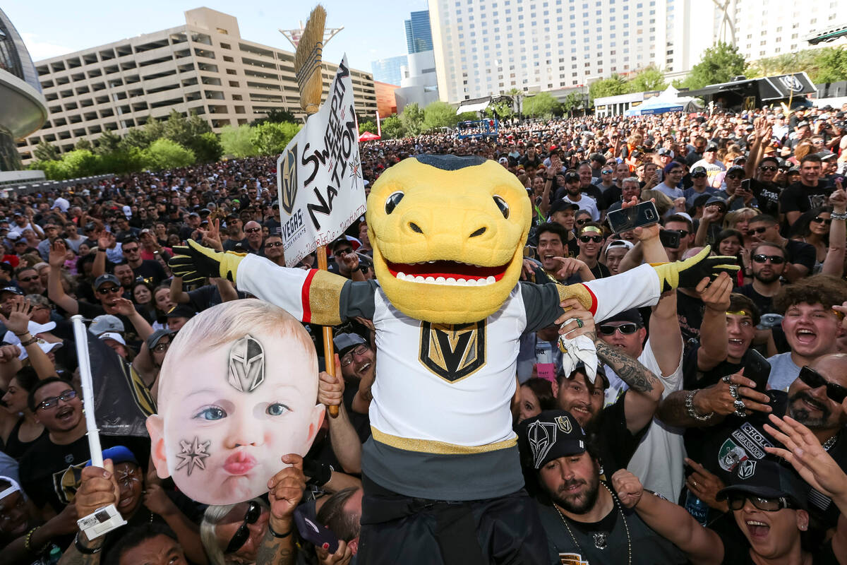 Vegas Golden Knights mascot Chance the Golden Gila Monster jumps on fans before Game 1 of the N ...