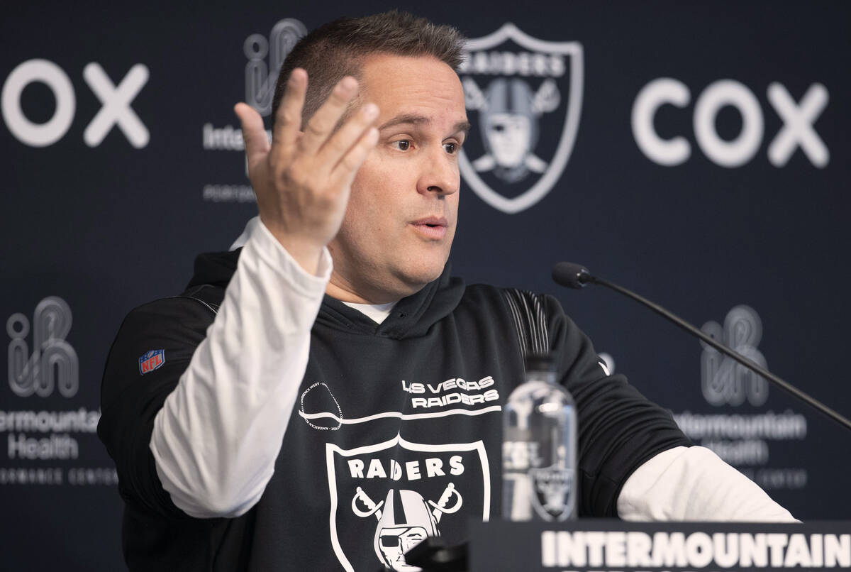Raiders head coach Josh McDaniels gestures as he answers a question during a news conference at ...