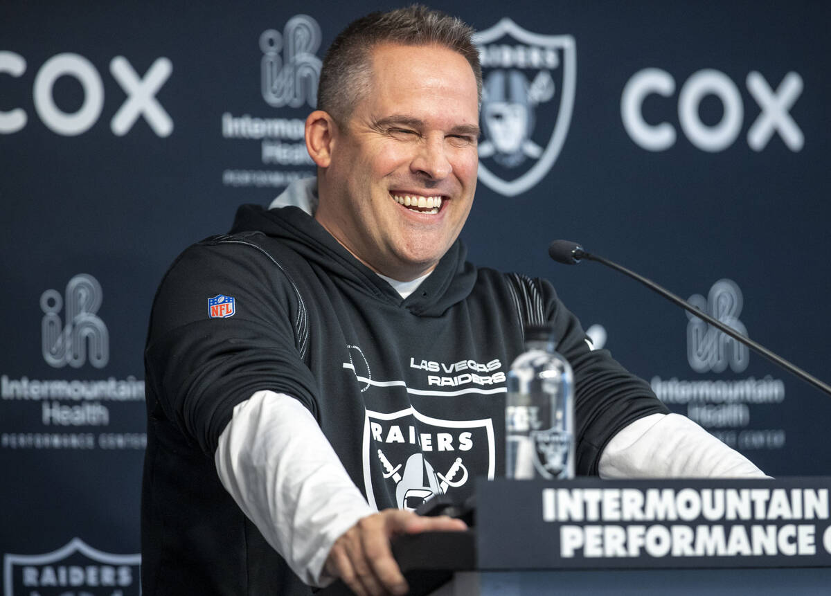 Raiders head coach Josh McDaniels reacts with laughter during a news conference at the Intermou ...