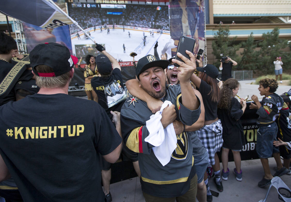 Golden Knights fans celebrate after the Knights defeated the Winnipeg Jets 2-1 during a watch p ...