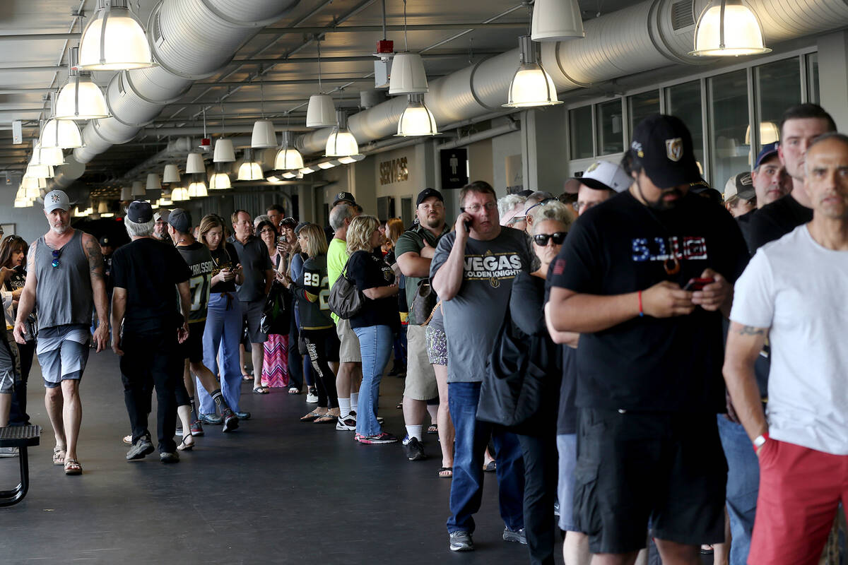 Over a hundred people line up outside the Arsenal retail store at the City National Arena in La ...