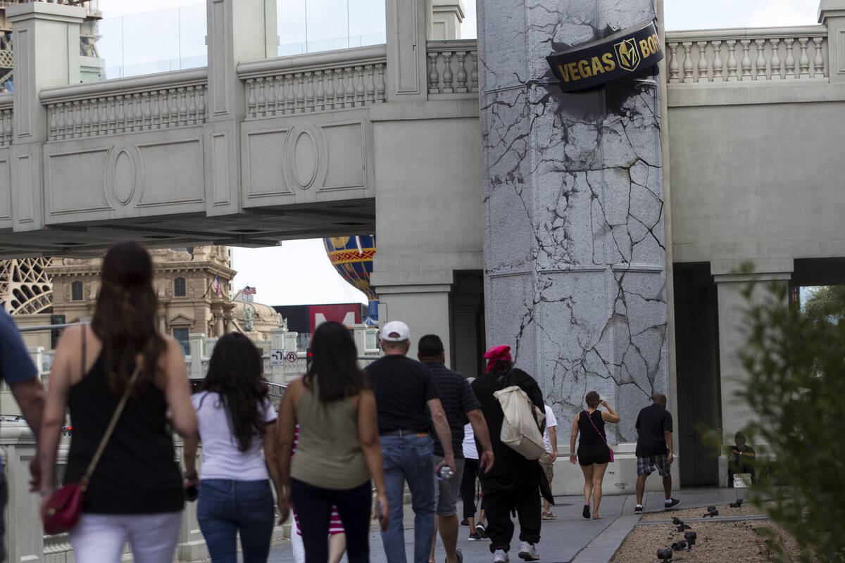 A giant puck promoting the Vegas Golden Knights on a pedestrian bridge at the intersection of F ...