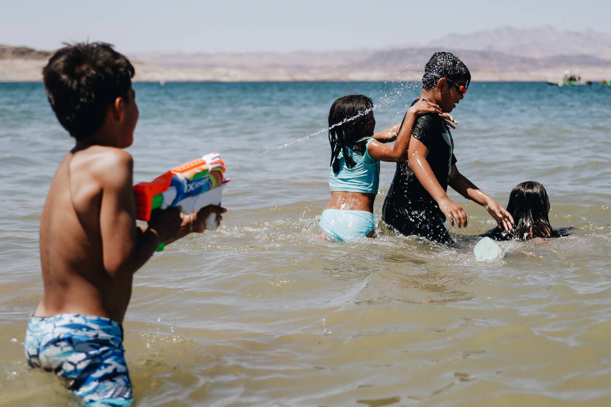 Armando Tirre III, 8, left, splashes Ivan Bojorquez, 10, as they play in the water on Sunday, M ...