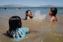 Emily Diaz, top/left, 13, splashes Armando Tirre III, 8, on Sunday, May 28, 2023, at Lake Mead, ...