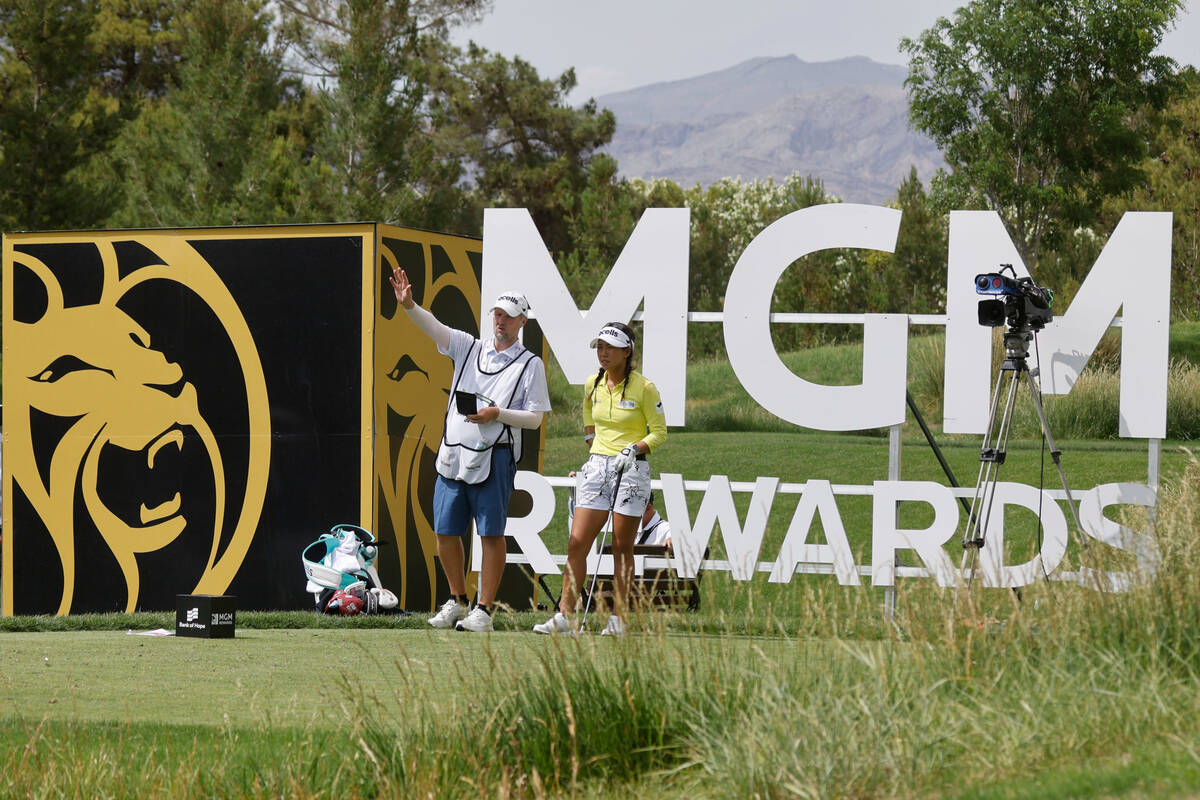 Jenny Shin of Korea talks with her caddie on the 13th hole before she tees off during the secon ...
