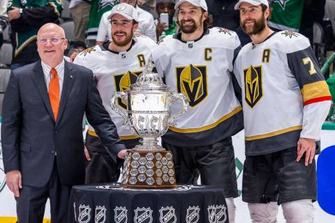 Bill Daly, Deputy commissioner of the NHL, awards the trophy to the Golden Knights after defeat ...