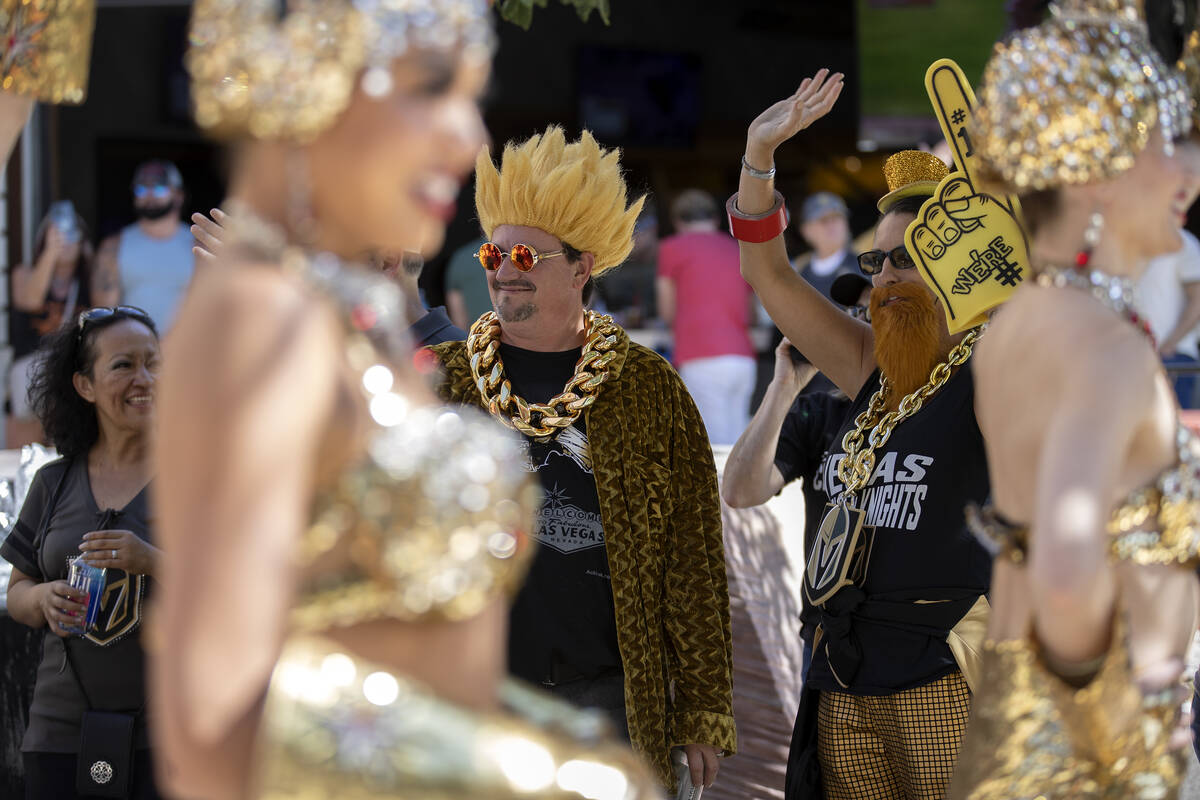 Dameron Wood and Tori Wood wave at the passing Golden Knights parade before Game 5 of the NHL h ...