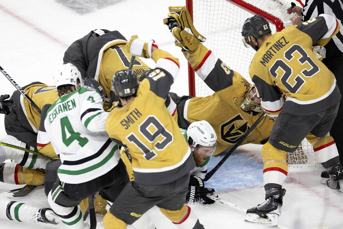 Golden Knights goaltender Adin Hill (33) holds up the saved puck in his glove as the Dallas Sta ...