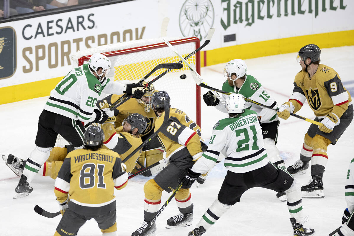 Dallas Stars left wing Jason Robertson (21) scores on Golden Knights goaltender Adin Hill (33) ...