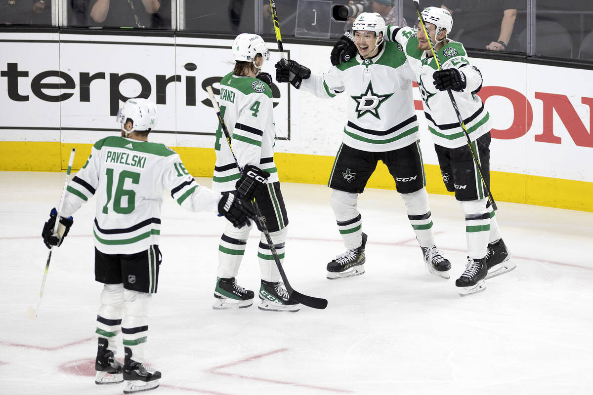 The Dallas Stars congratulate Dallas Stars left wing Jason Robertson, third from left, during t ...