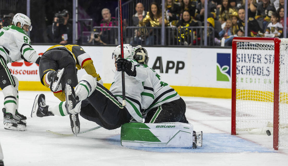 Golden Knights center Ivan Barbashev (49) scores as he trips over Dallas Stars left wing Mason ...