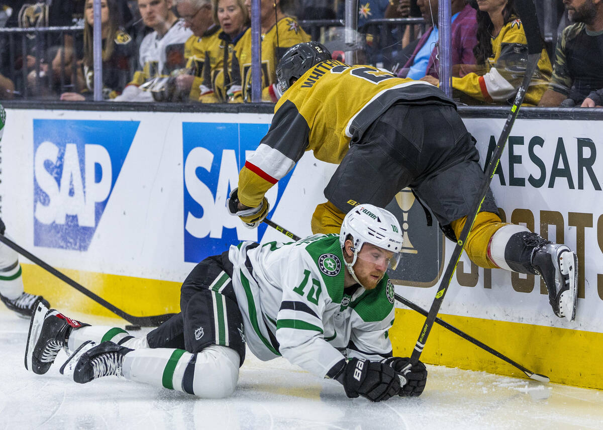 Golden Knights defenseman Zach Whitecloud (2) takes down Dallas Stars center Ty Dellandrea (10) ...