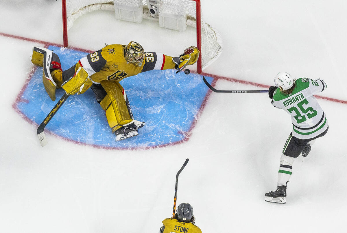 Golden Knights goaltender Adin Hill (33) stretches out to deny a goal by Dallas Stars left wing ...