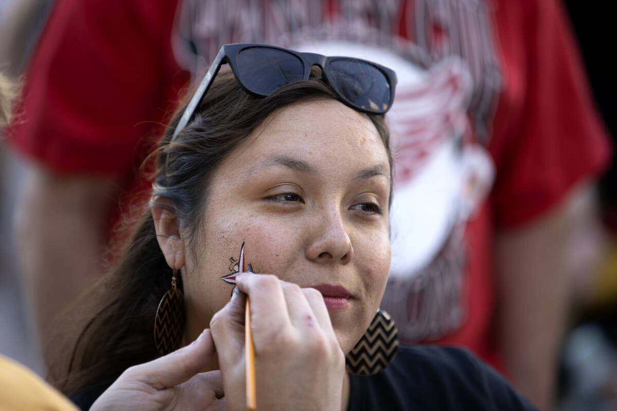 Eileen Almaguer has her face painted with Golden Knights insignia before Game 5 of the NHL hock ...