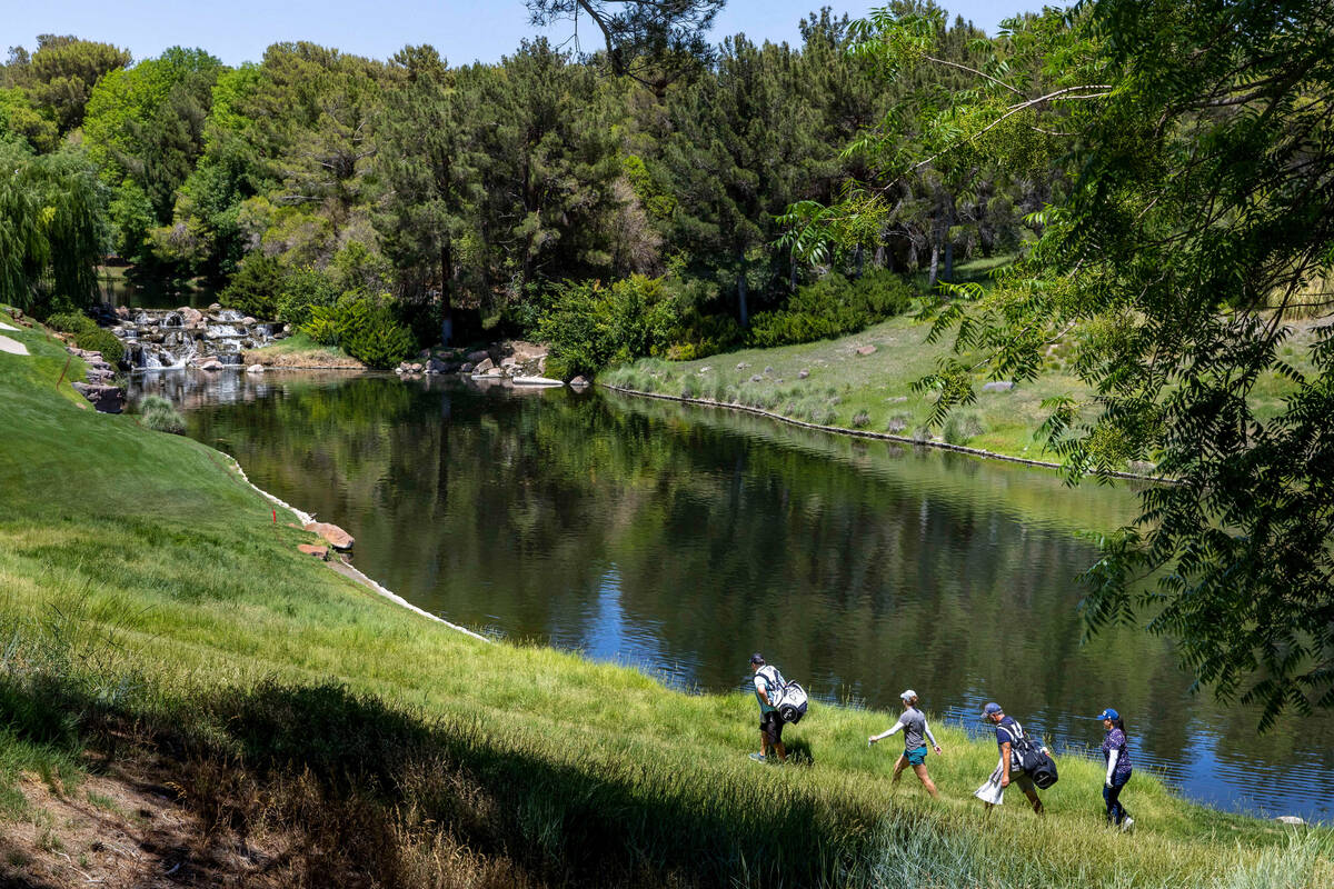 Ally Ewing, center left, and Angel Yin, right, join their caddies as they walk along the scenic ...