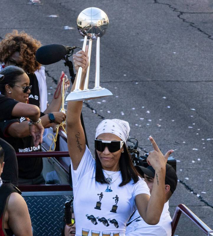 Las Vegas Aces' A'ja Wilson holds up the championship trophy during the team's WNBA Championshi ...