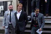 Daniel Penny, center, is walked by New York Police Department detectives detectives out of the ...
