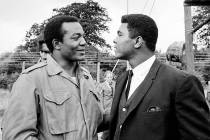 FILE - In this Aug. 5, 1966, file photo, heavyweight boxer Muhammad Ali, right, visits Clevelan ...