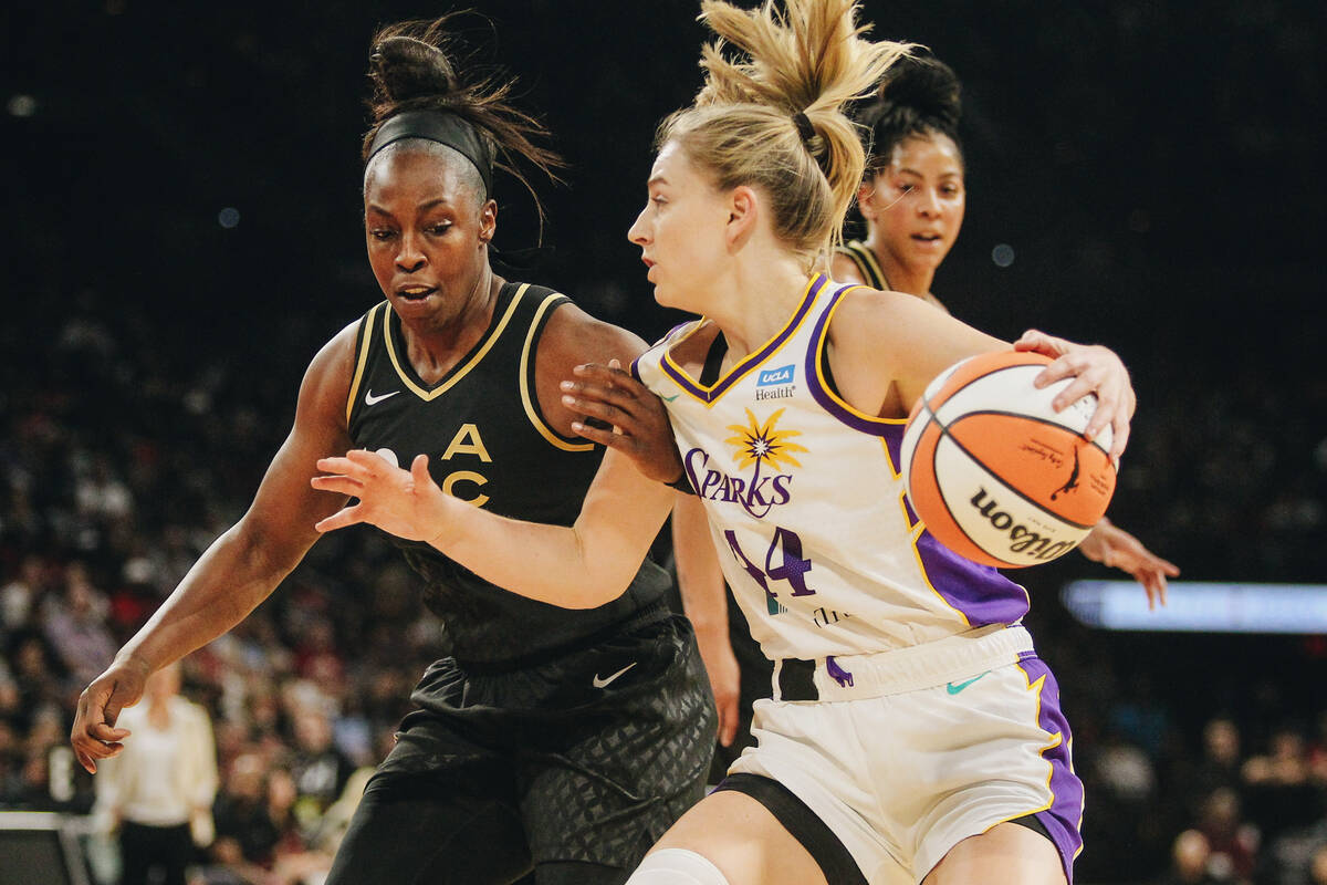 Los Angeles Sparks guard Karlie Samuelson (44) drives the ball against Aces guard Chelsea Gray ...