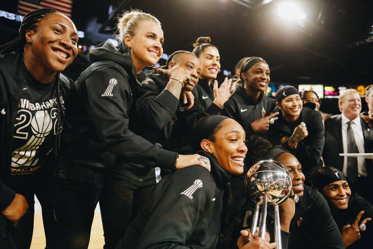 The Aces pose with the 2022 WNBA championship trophy and their rings on Saturday, May 27, 2023, ...