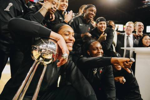 The Aces pose with the 2022 WNBA championship trophy and their rings on Saturday, May 27, 2023, ...