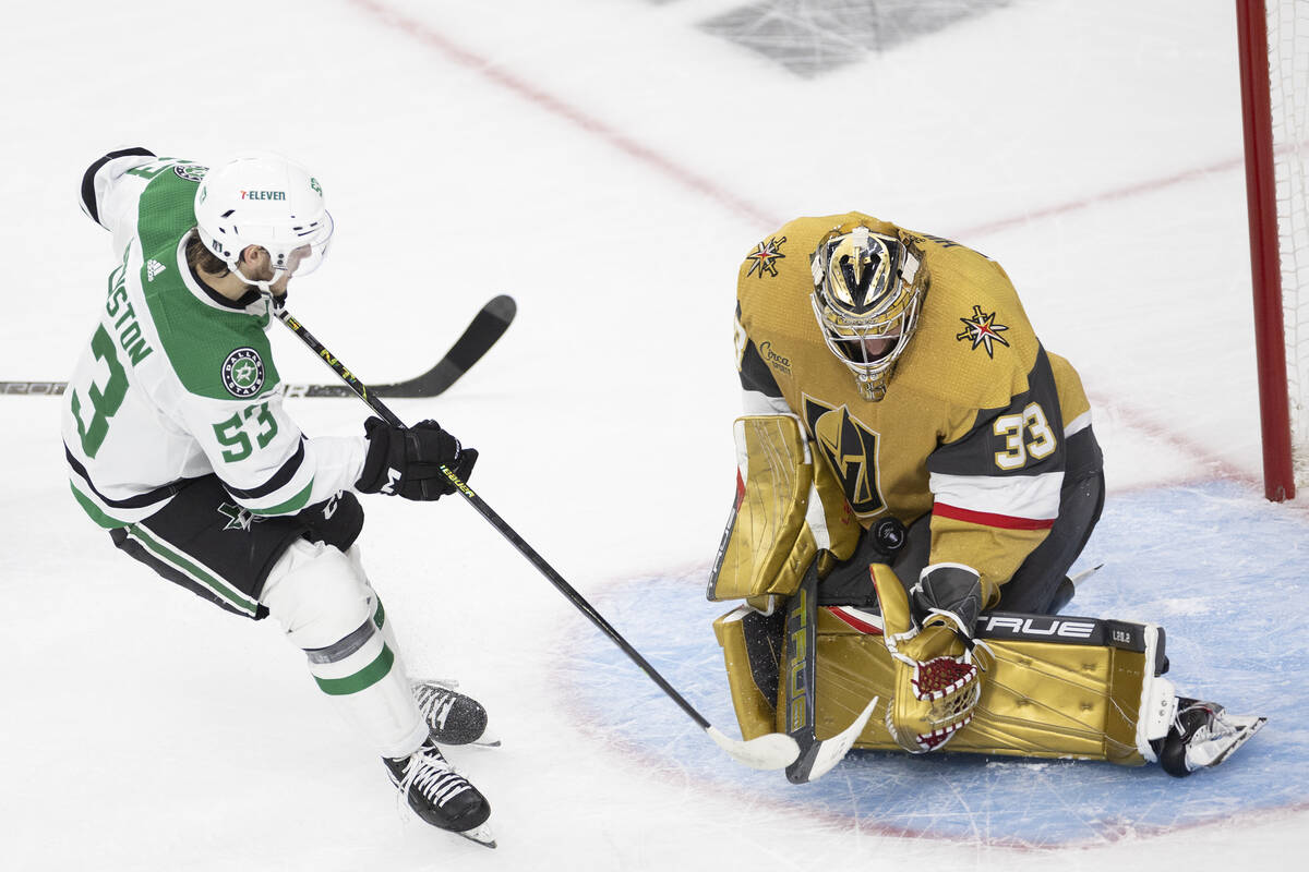 Golden Knights goaltender Adin Hill (33) saves the puck against a shot by Dallas Stars center W ...