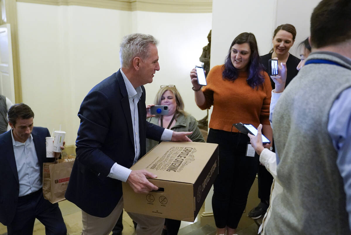 House Speaker Kevin McCarthy of Calif., carries food for members of the press covering deb ...