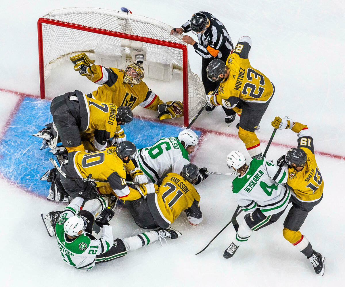 Golden Knights goaltender Adin Hill (33) shows he has the puck in near miss by Dallas Stars lef ...