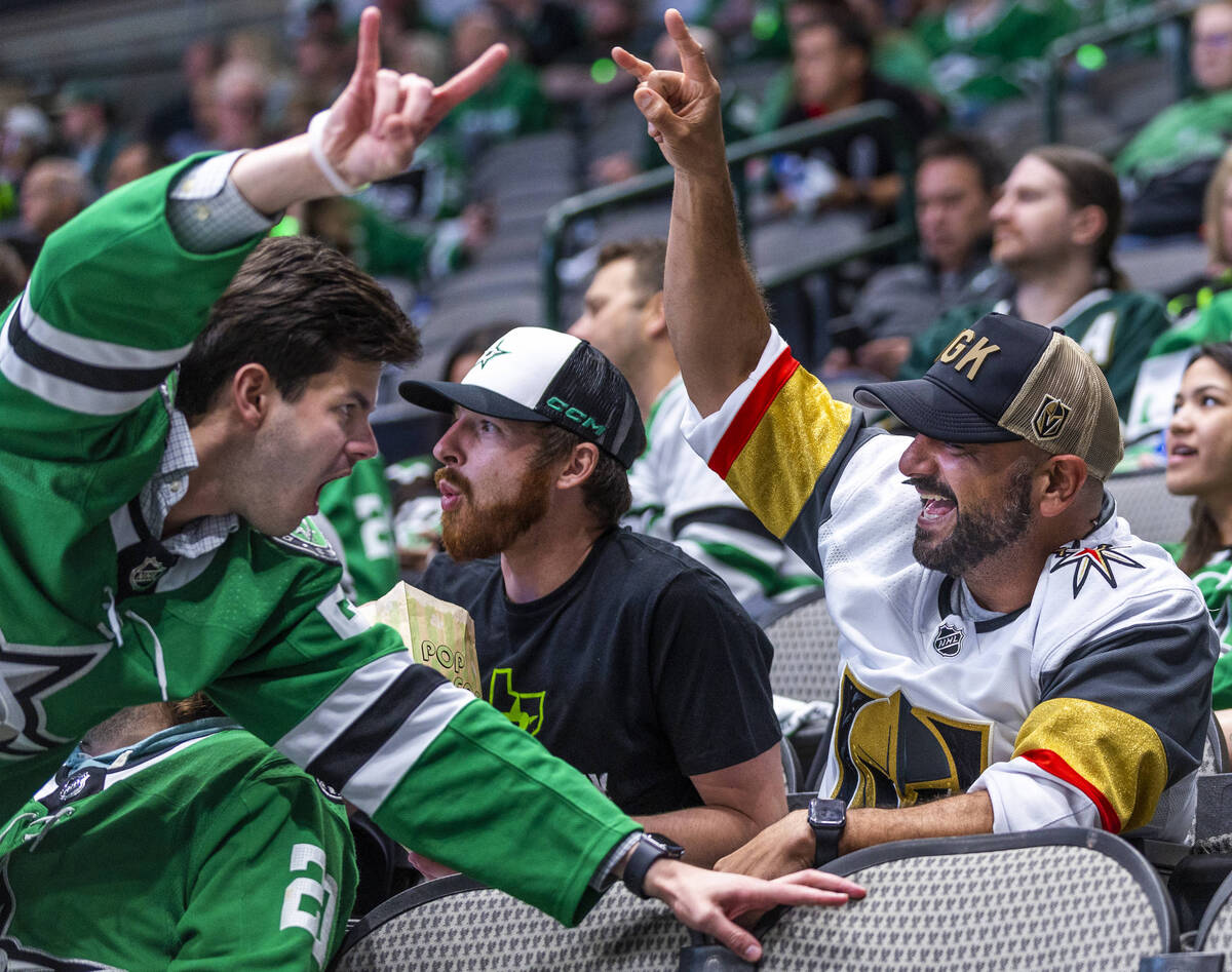 A Golden Knights fan and Dallas Stars fan have a cheer off during the third period in Game 6 of ...