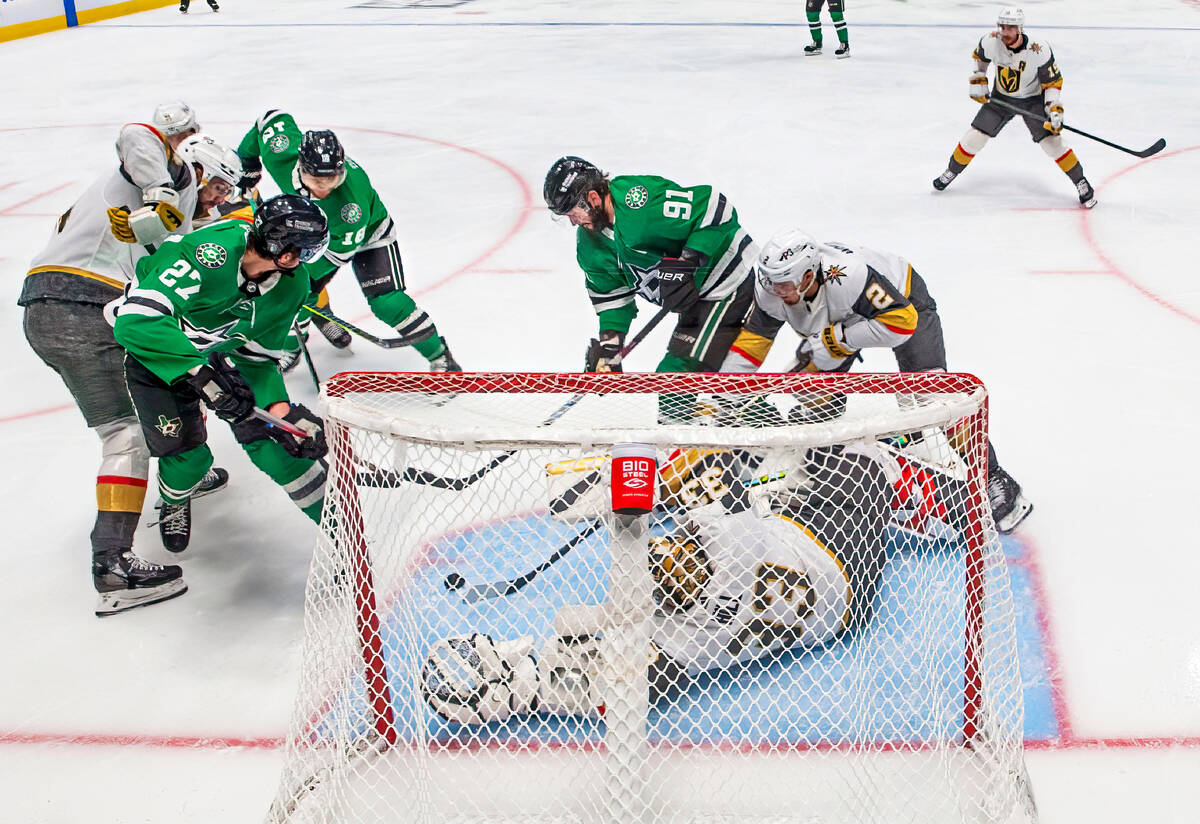 Golden Knights goaltender Adin Hill (33) dives to save a shot on goal by Dallas Stars center Ty ...