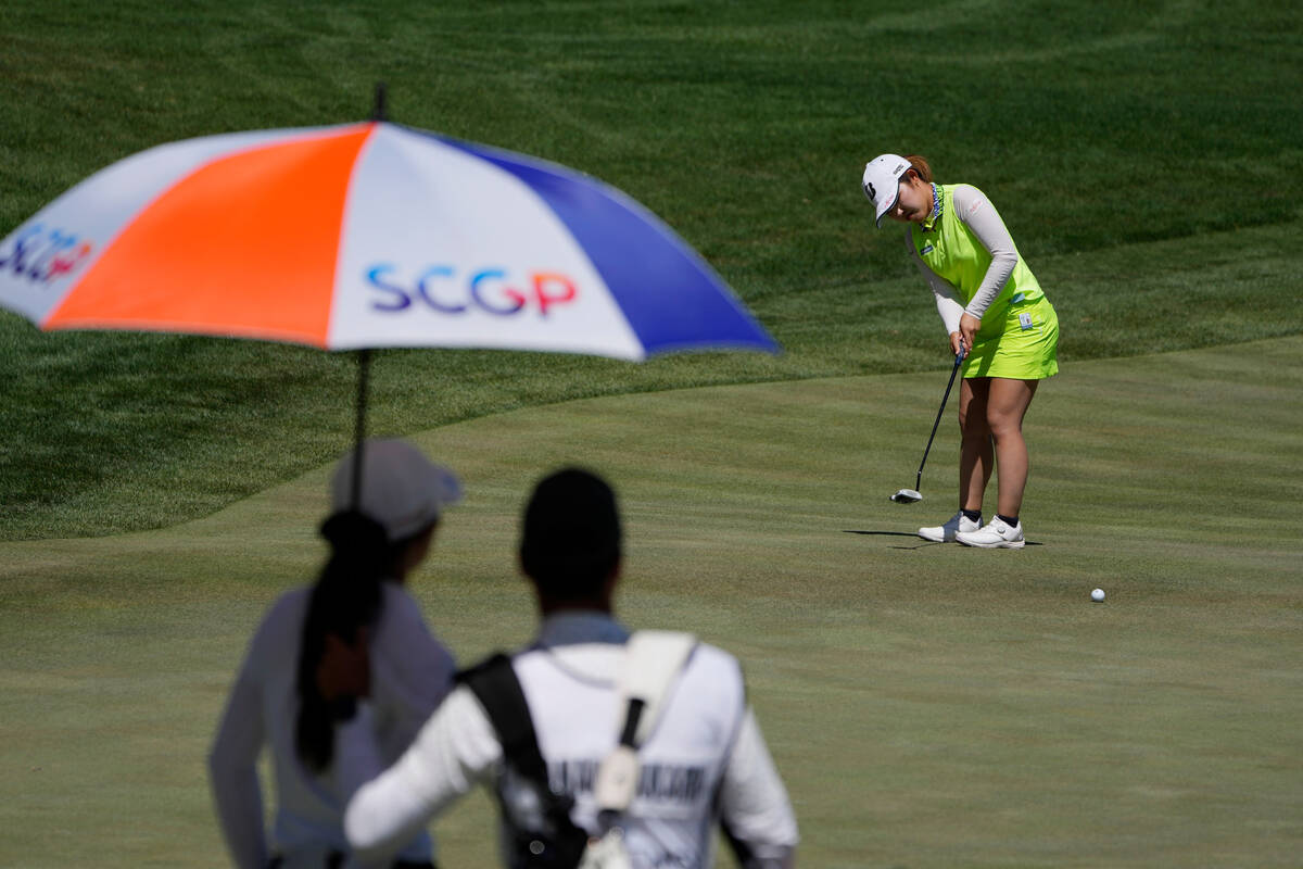Ayaka Furue putts on the first green as Pajaree Anannarukarn and her caddy watch during the fin ...
