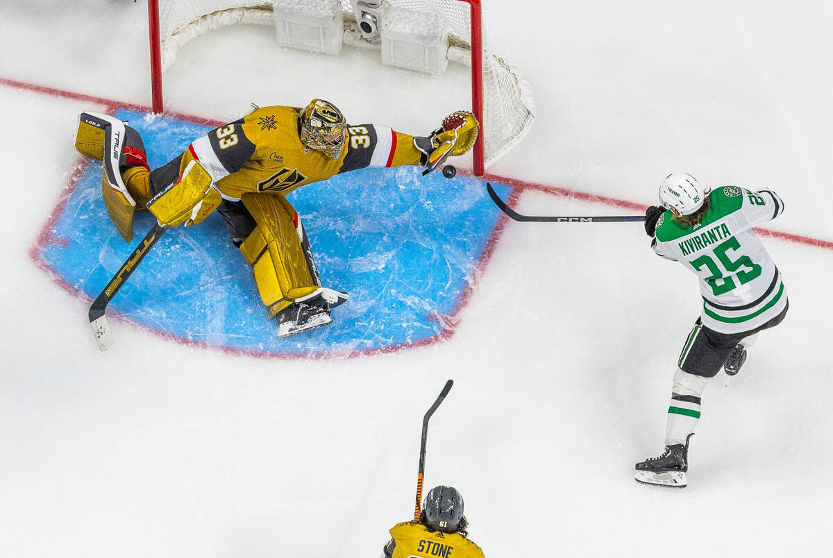 Golden Knights goaltender Adin Hill (33) stretches out to deny a goal by Dallas Stars left wing ...