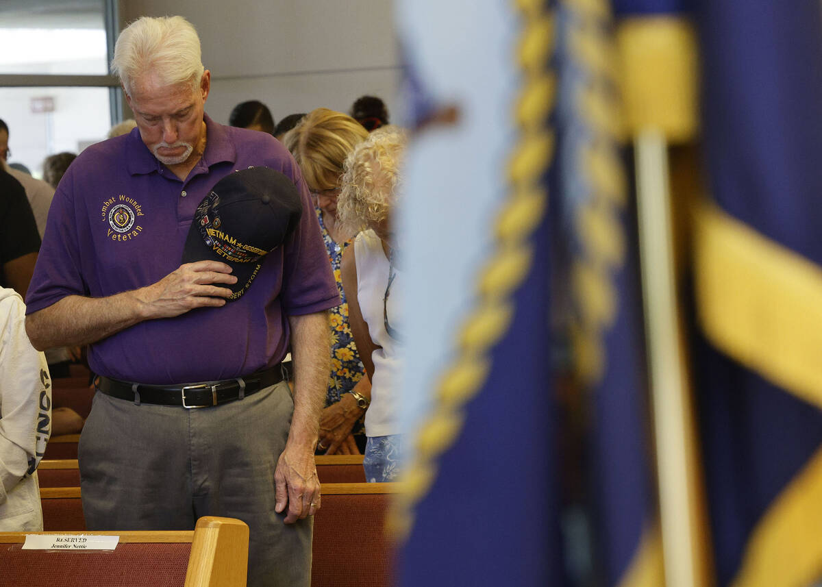 Purple Heart recipient U.S. Army veteran Dan Peterson of Henderson prays during a Memorial Day ...