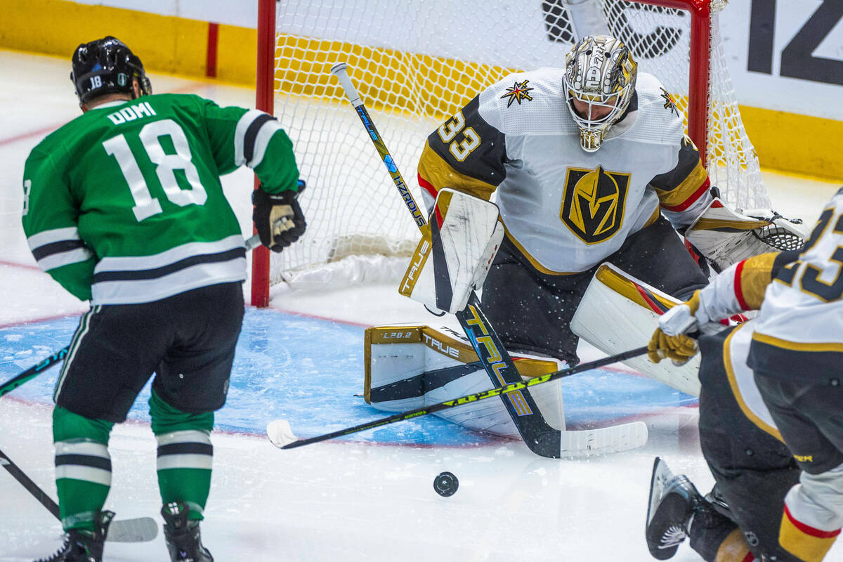 Golden Knights goaltender Adin Hill (33) rejects a shot by Dallas Stars center Max Domi (18) du ...