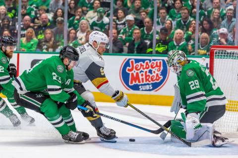 Golden Knights center Jack Eichel (9) loses the puck on a drive between Dallas Stars goaltender ...