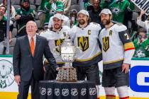 Bill Daly, Deputy commissioner of the NHL, awards the trophy to the Golden Knights after defeat ...