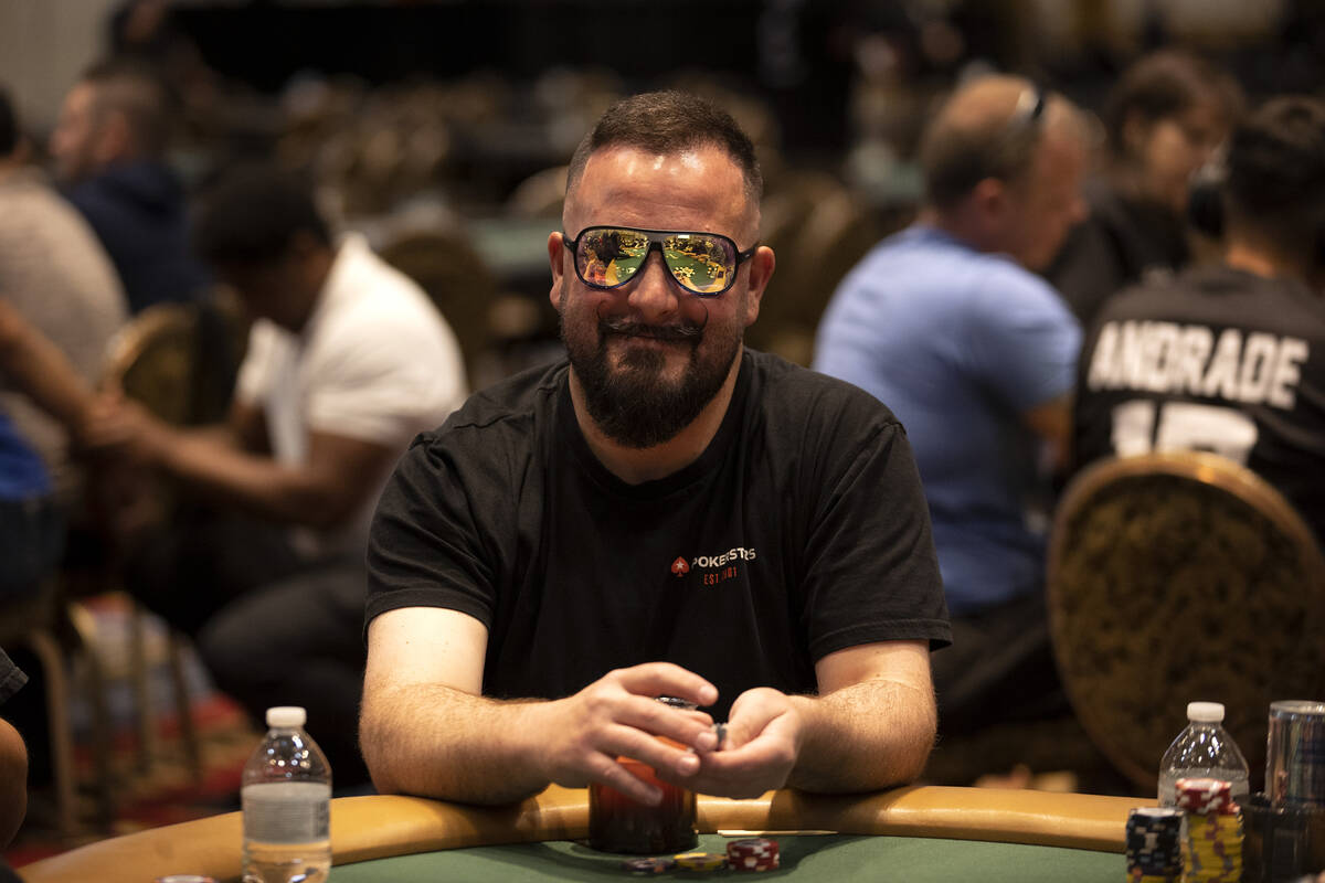 A player smiles while competing during the first day of the World Series of Poker at Horseshoe ...