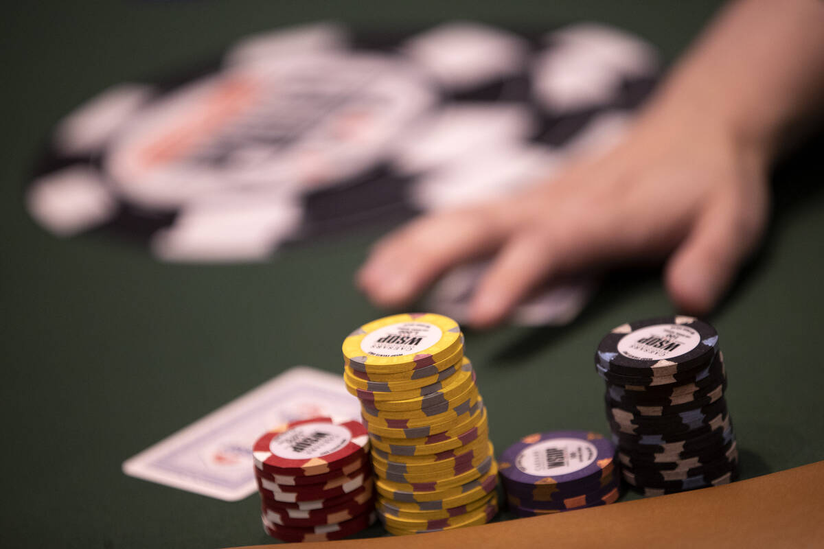A dealer hands out cards during the first day of the World Series of Poker at Horseshoe Las Veg ...