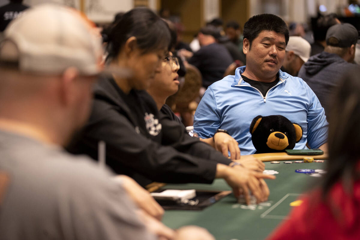 Jefferson Amasaki, of Las Vegas, holds his “poker coach,” Coach Ricardo, a teddy ...