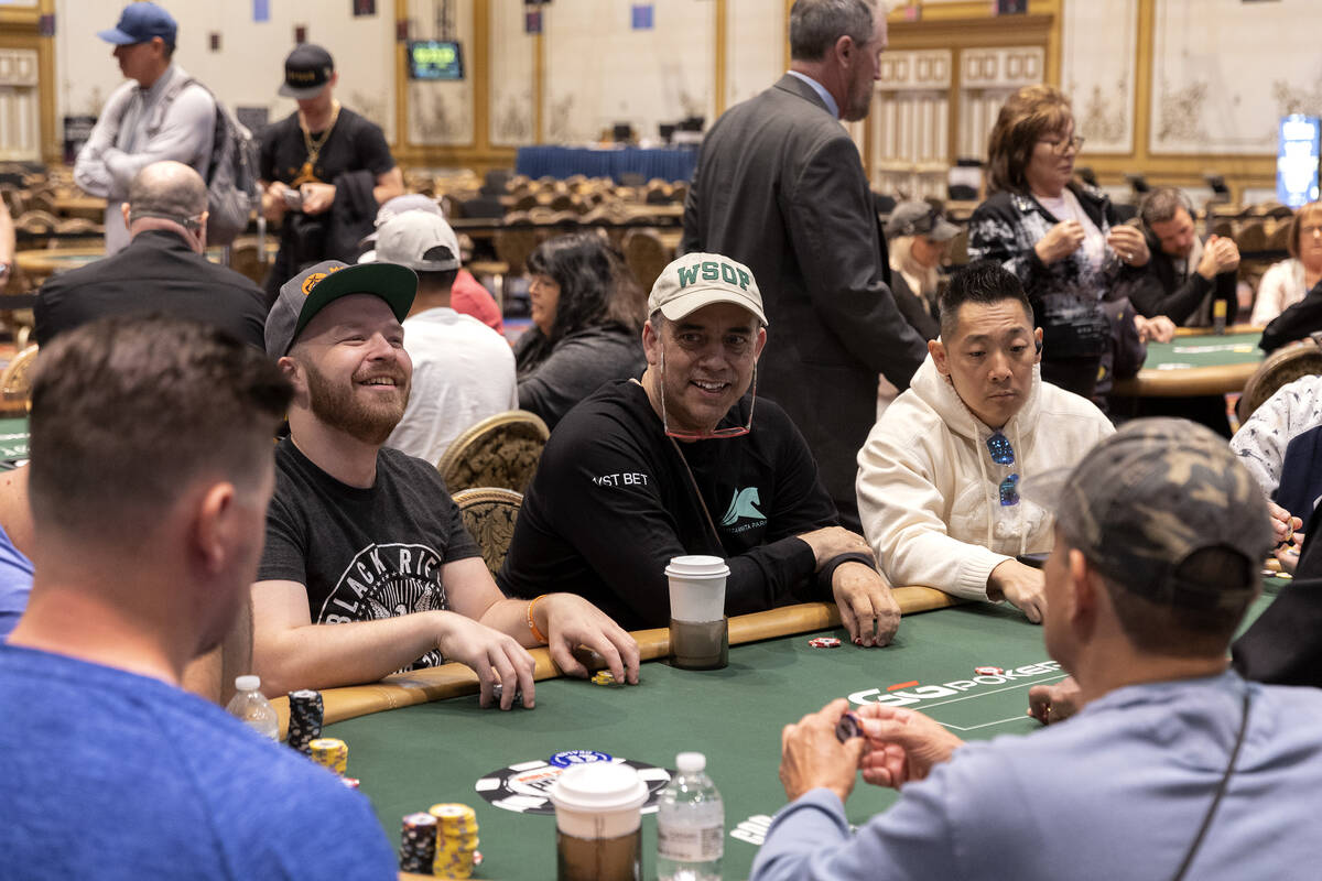 Players laugh at their table during the first day of the World Series of Poker at Horseshoe Las ...