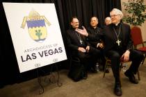 Archbishop of Las Vegas George Leo Thomas, right, smiles, during a news conference at the Archd ...
