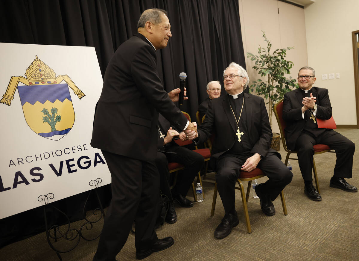 Bishop of Salt Lake City Oscar Solis, right, shakes hands with Archbishop of Las Vegas George L ...