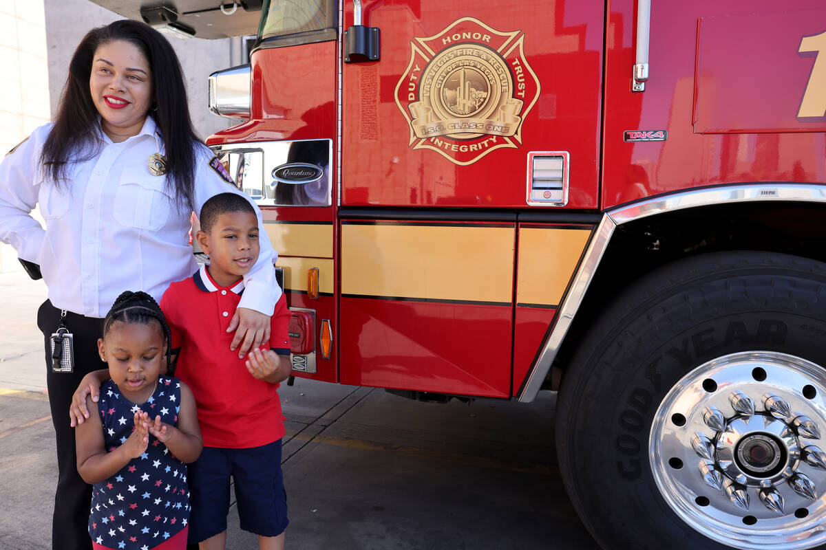 Reign Gray, 2, and Adonis Gray, 6 pose as their mother, Las Vegas Fire and Rescue Assistant Fir ...
