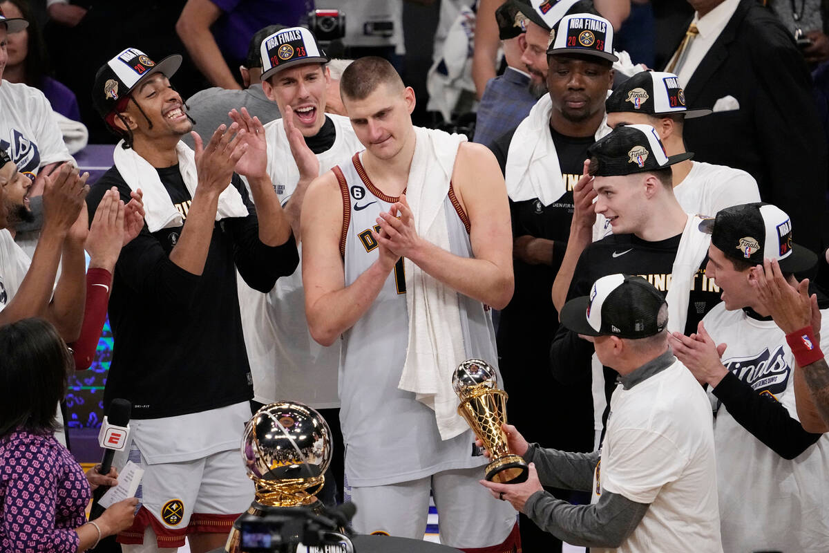 Denver Nuggets center Nikola Jokic, center, is presented with the series MVP trophy after defea ...