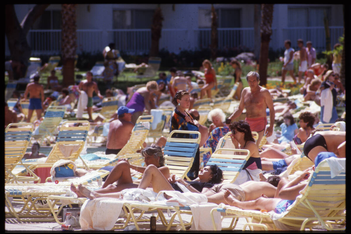 People relaxing in lounge chairs at the swimming pool at the Tropicana Hotel and Casino 3801 So ...
