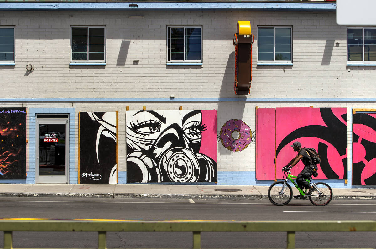 A cyclist moves past a mural at the Donut Bar along E. Carson Avenue in Downtown Las Vegas on S ...