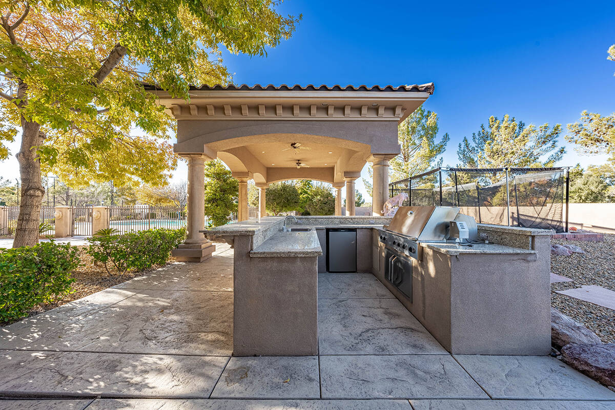 The home is built for entertaining and has an outdoor kitchen in the resort-style backyard. (Be ...