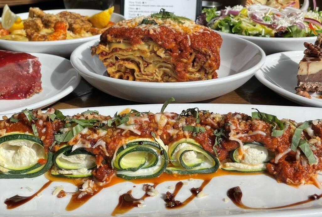 A stuffed zucchini roll, front, and lasagna, center, from Tarantino's, a family-owned vegan Ita ...