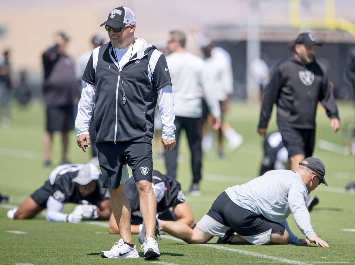 Raiders head coach Josh McDaniels walks through practice during an organized team activity at I ...