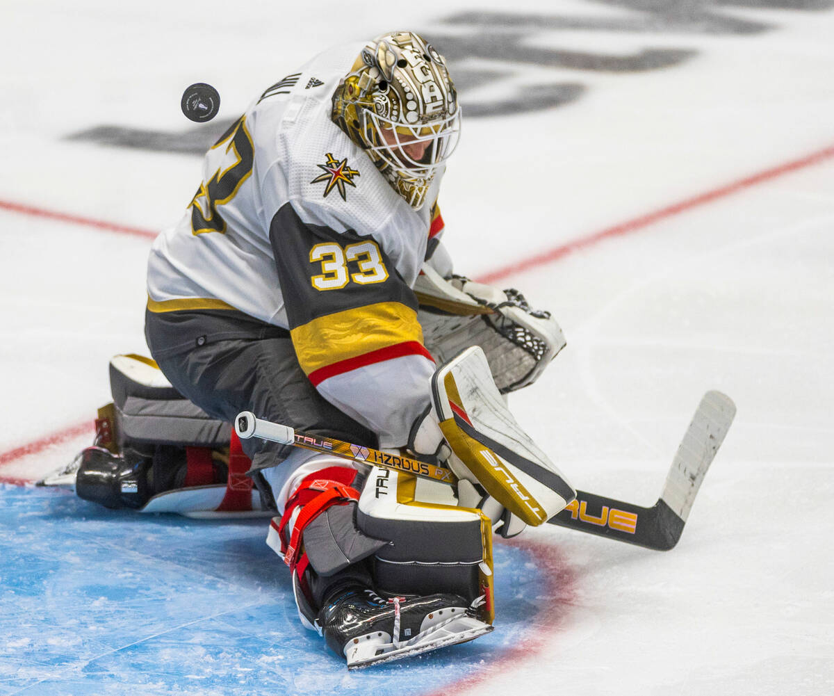 Golden Knights goaltender Adin Hill (33) deflects away another shot attempt from the Dallas Sta ...